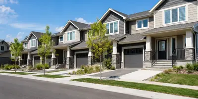 Modern townhomes on a sunny street.